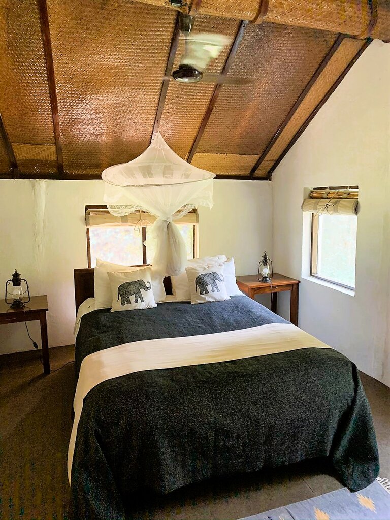 Schlafzimmer mit Bett im Cottage at Tiger Tops Lodge | © Constanze Schwarz